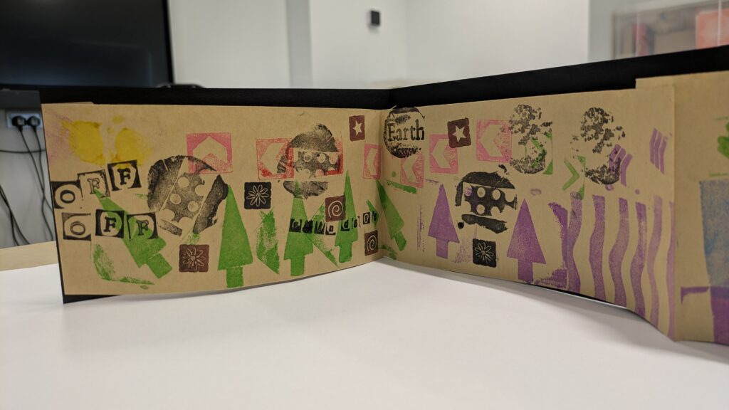 A page with colourful prints and patterns including green and purple trees, the words 'off off'